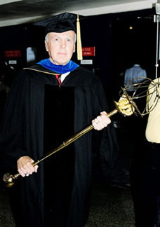Faculty holding mace for Drexel U.