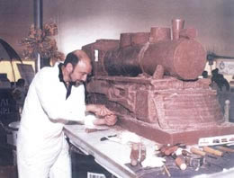 Photo of Jim Victor carving a chocolate train